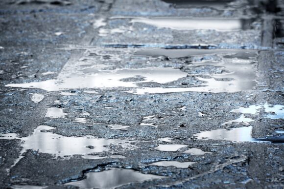 Rain,puddles,on,a,pavement,in,the,city